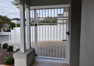 Custom Semaphore Design Gate and panel enclosing front entrance.