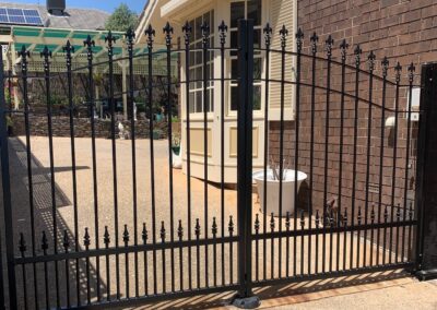 Double Gate by seaside in St Peters Design with Flat bar Arched top rails and extra row of Cardinal Spears at the bottom to keep little dogs in safe.